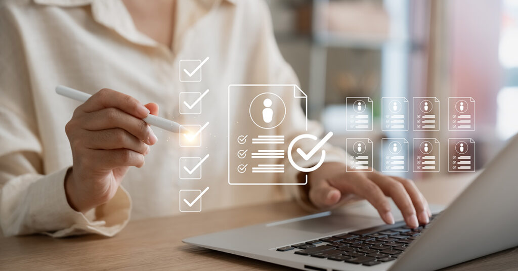 Photo of an HR professional using a computer to screen resumes.